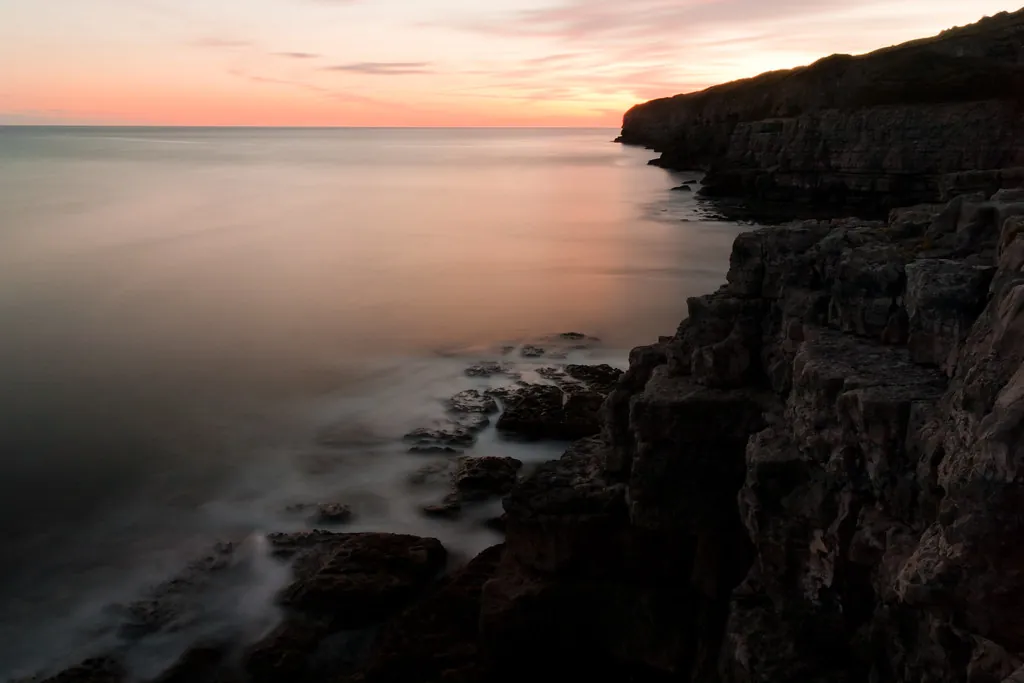 Acantilado junto al mar en calma al atardecer